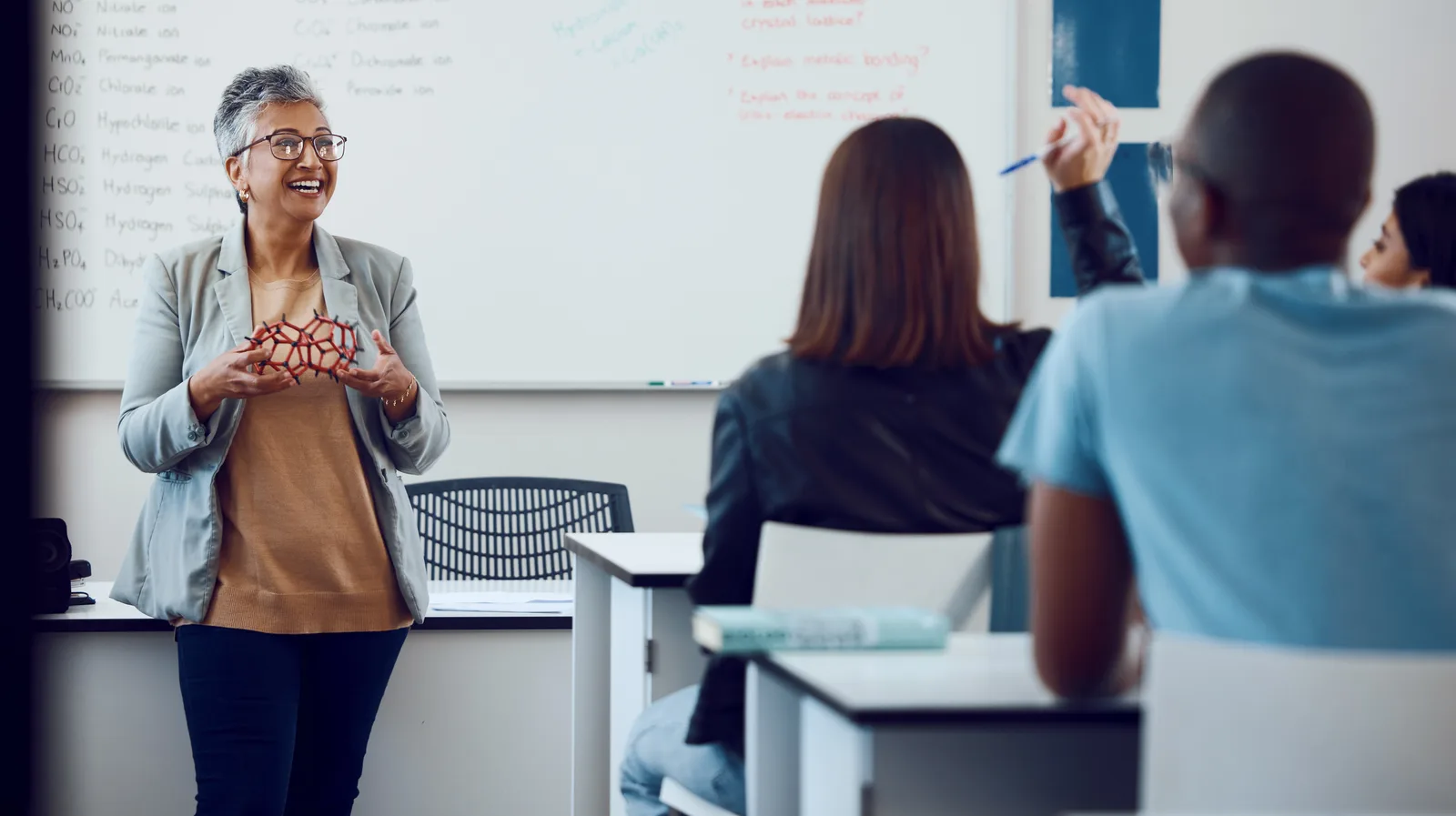 A teacher working with students in a classroom