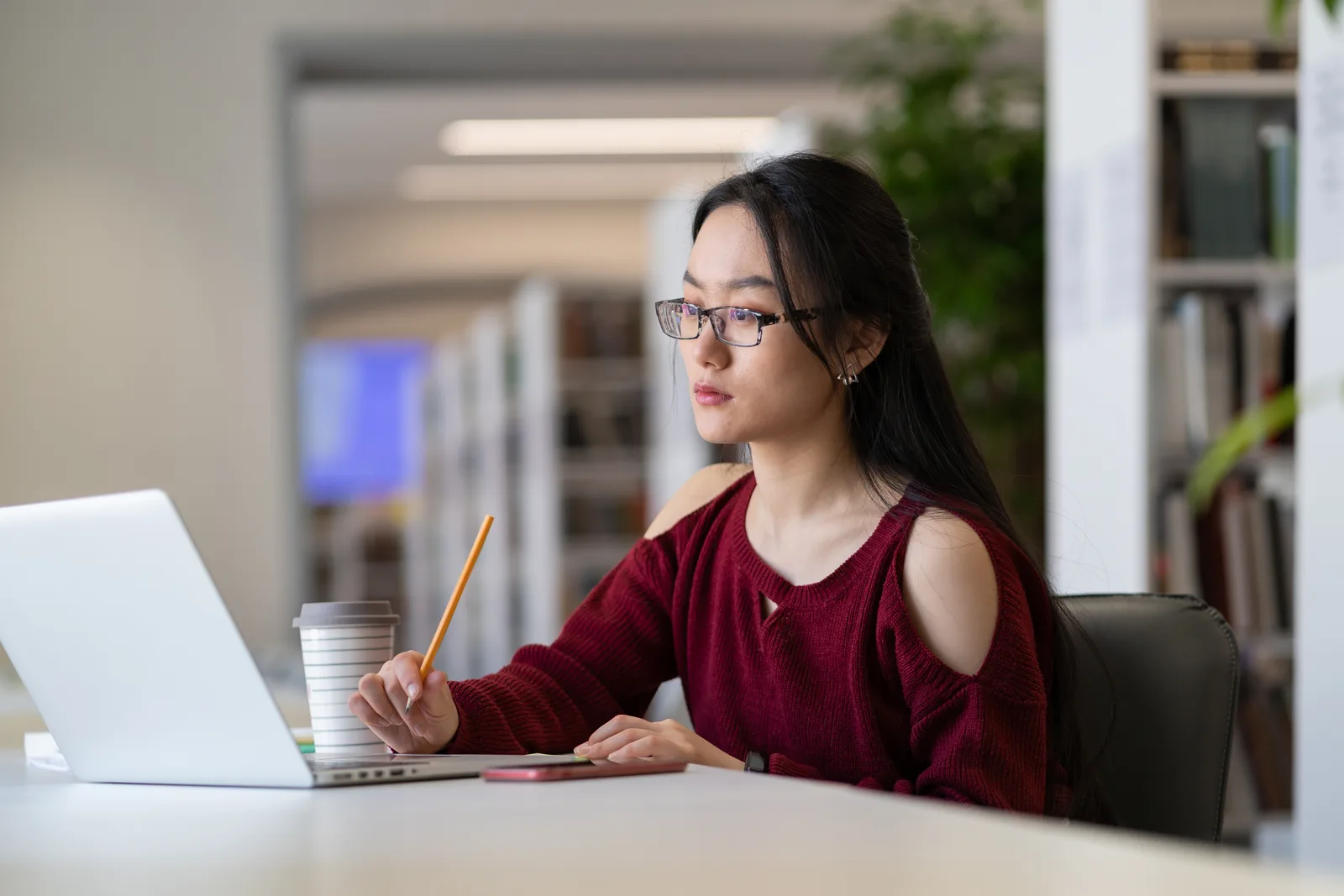 A student studying with her laptop